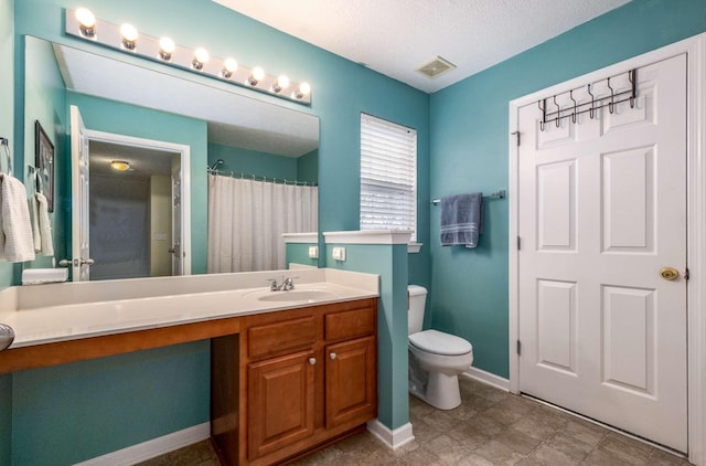 bathroom featuring vanity, a shower with shower curtain, a textured ceiling, and toilet