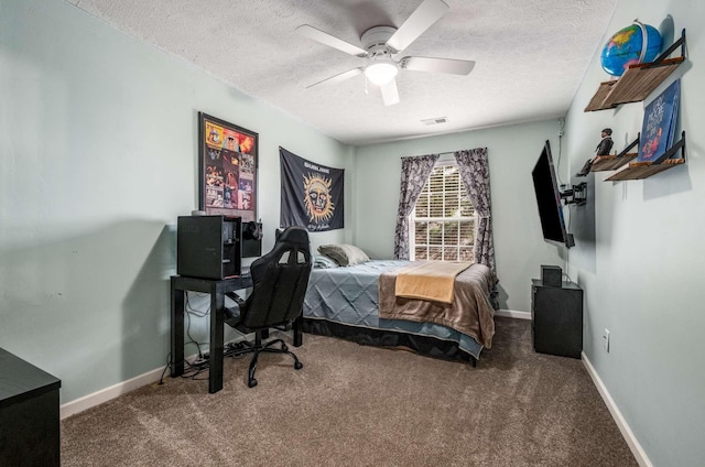 carpeted bedroom featuring a textured ceiling and ceiling fan