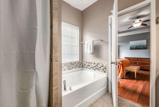 bathroom featuring a bathing tub, wood-type flooring, and tile walls