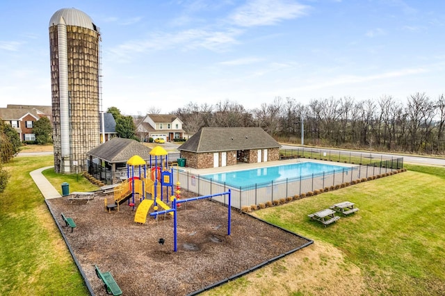 exterior space featuring a lawn and a fenced in pool