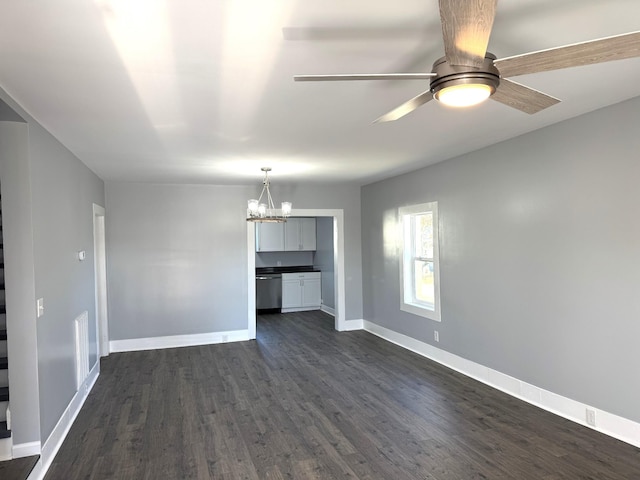 unfurnished living room featuring ceiling fan with notable chandelier and dark wood-type flooring