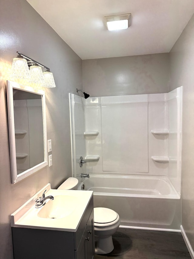 full bathroom with washtub / shower combination, wood-type flooring, vanity, and toilet