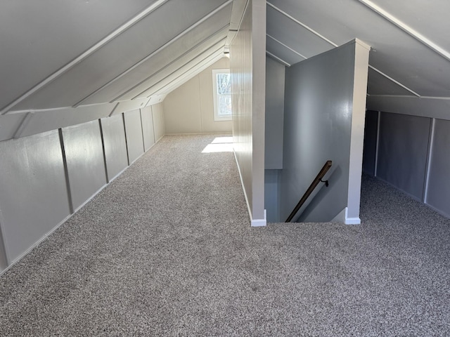 additional living space with carpet floors and vaulted ceiling