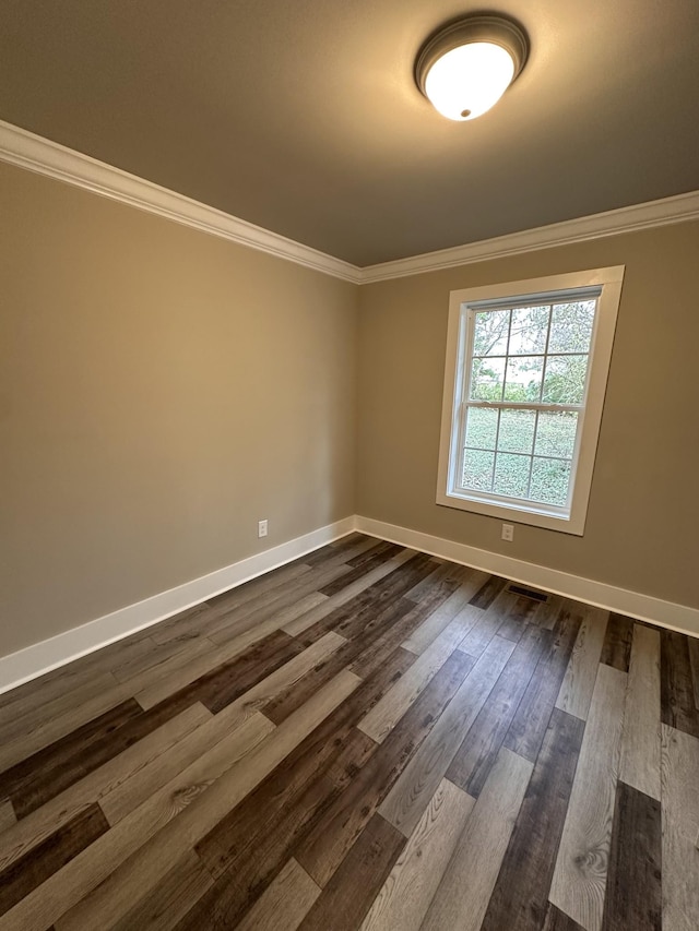 spare room with wood-type flooring and ornamental molding