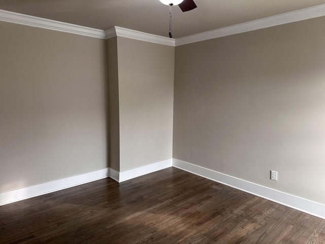 empty room featuring ceiling fan, crown molding, and dark wood-type flooring