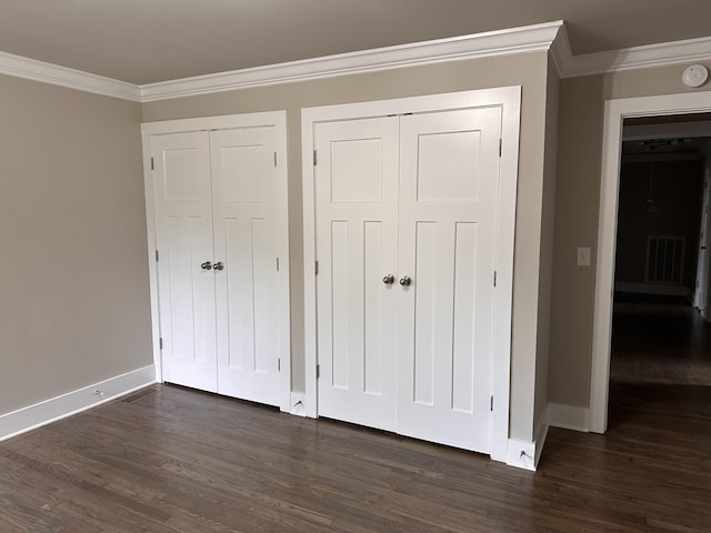 unfurnished bedroom featuring dark hardwood / wood-style flooring and crown molding