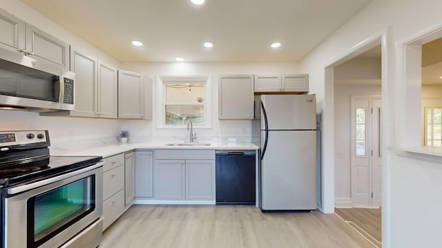 kitchen featuring sink, stainless steel appliances, and light hardwood / wood-style floors