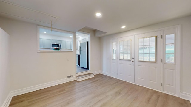 entrance foyer with light hardwood / wood-style flooring