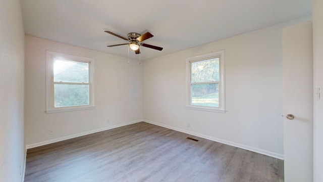 unfurnished room with ceiling fan and hardwood / wood-style floors