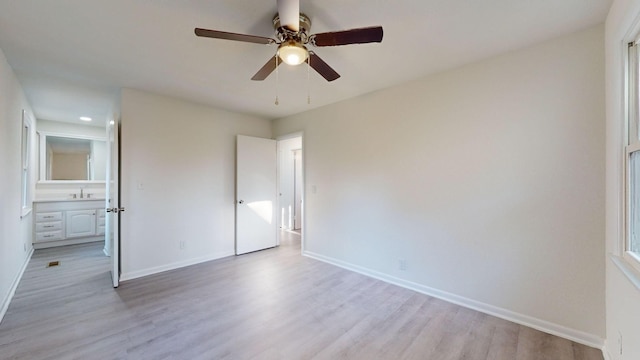 unfurnished bedroom with ensuite bath, ceiling fan, light hardwood / wood-style flooring, and sink