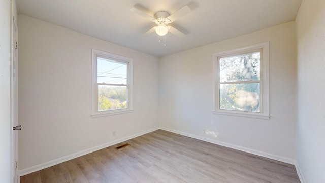 spare room featuring ceiling fan and light hardwood / wood-style flooring