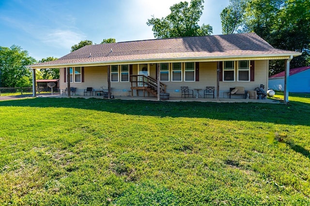 back of house with a yard and a patio