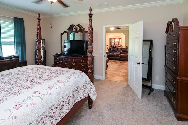 carpeted bedroom with ceiling fan and crown molding