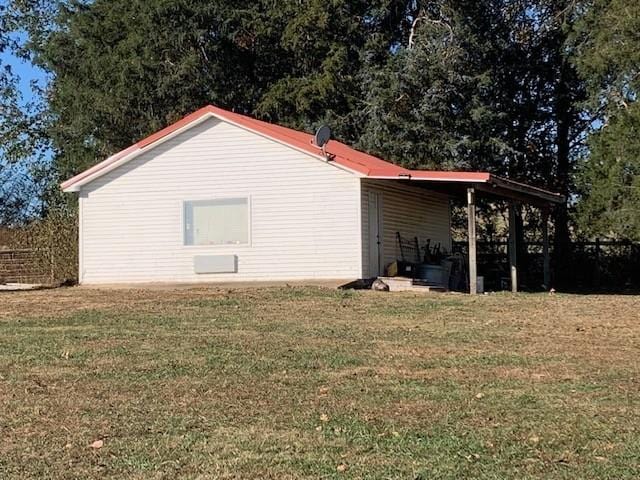 view of side of home with a yard