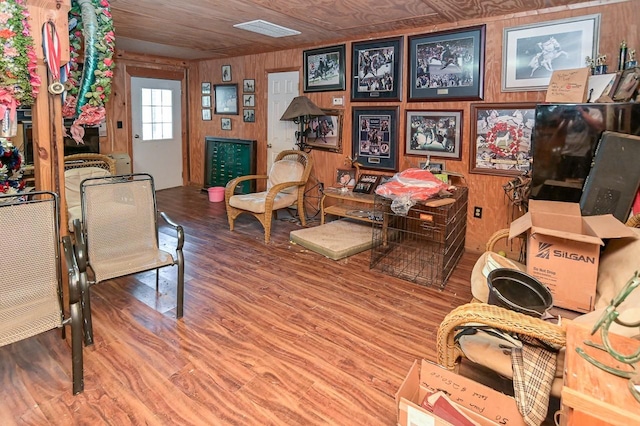 interior space featuring wood walls, hardwood / wood-style floors, and wood ceiling