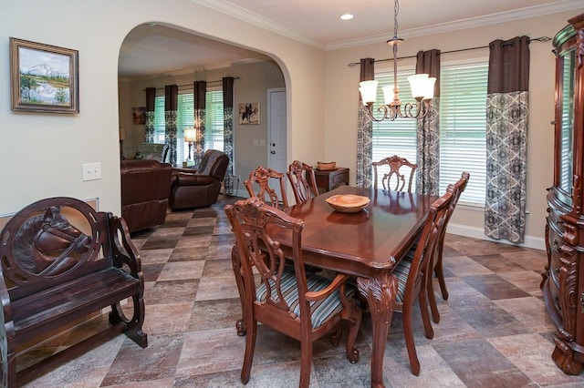 dining room with crown molding and an inviting chandelier