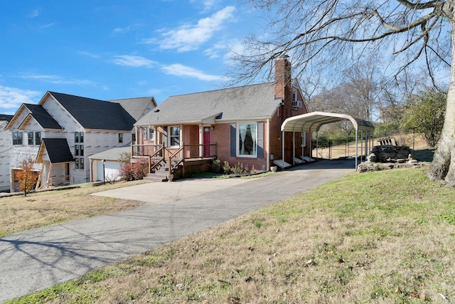 view of front facade with a carport, a garage, and a front yard