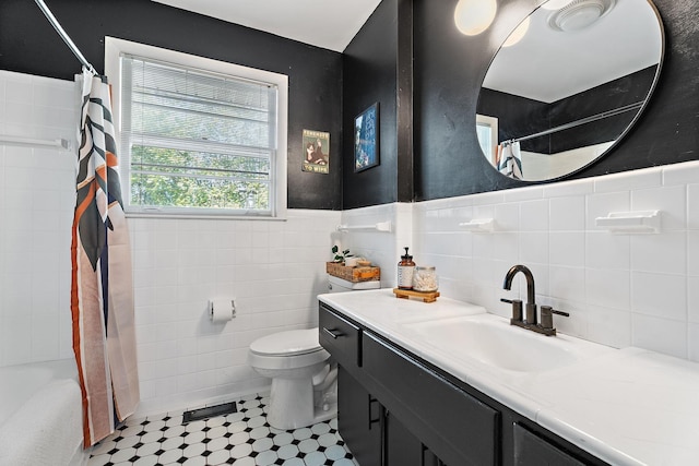 full bathroom with shower / bath combo with shower curtain, vanity, tile walls, and toilet