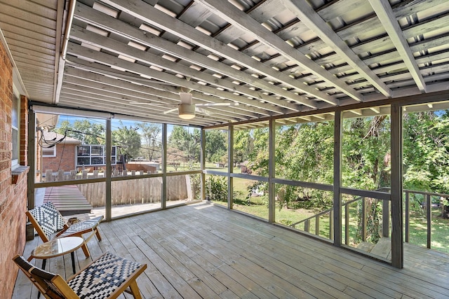 unfurnished sunroom with ceiling fan and a wealth of natural light