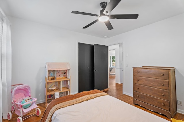 bedroom with ceiling fan and wood-type flooring