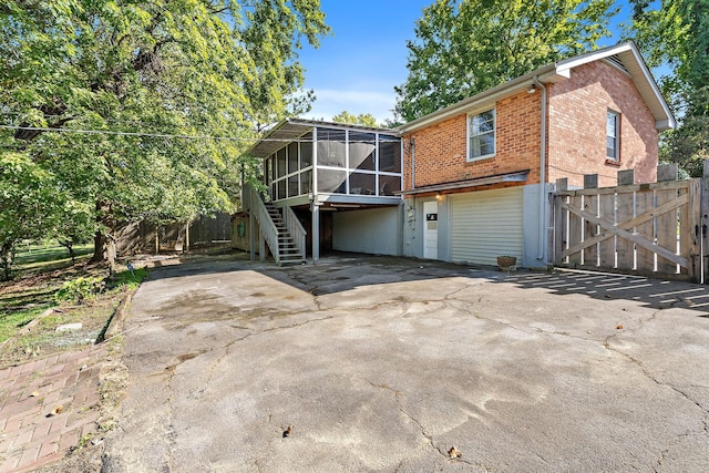 rear view of property with a sunroom