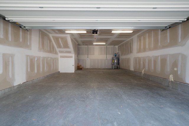 garage with water heater and a garage door opener