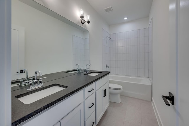 full bathroom with vanity, tiled shower / bath combo, toilet, and tile patterned flooring