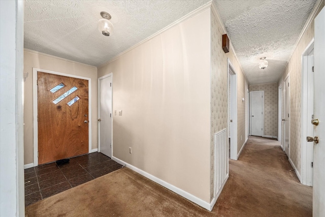 carpeted entryway with a textured ceiling and ornamental molding