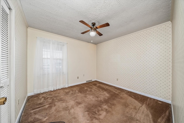 carpeted spare room with a textured ceiling, ceiling fan, and crown molding