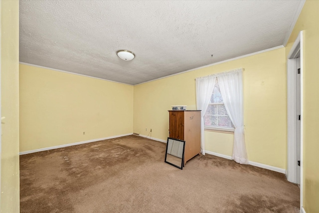 empty room with carpet flooring, ornamental molding, and a textured ceiling