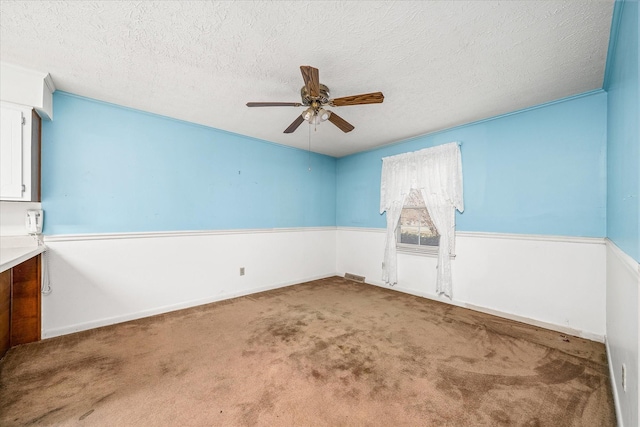 unfurnished room with carpet floors and a textured ceiling