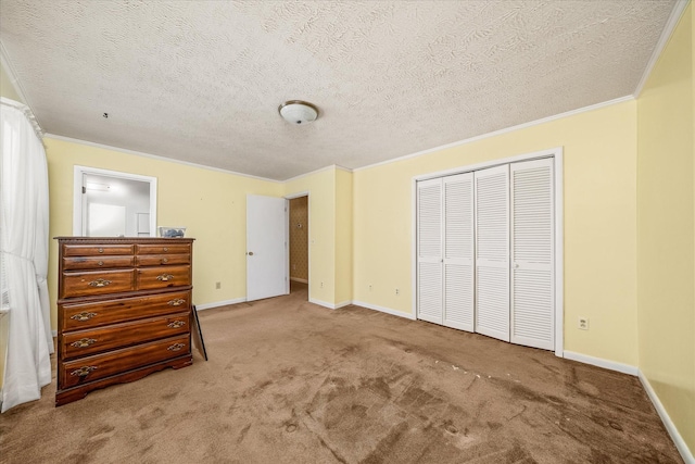 unfurnished bedroom featuring a textured ceiling, carpet floors, a closet, and crown molding