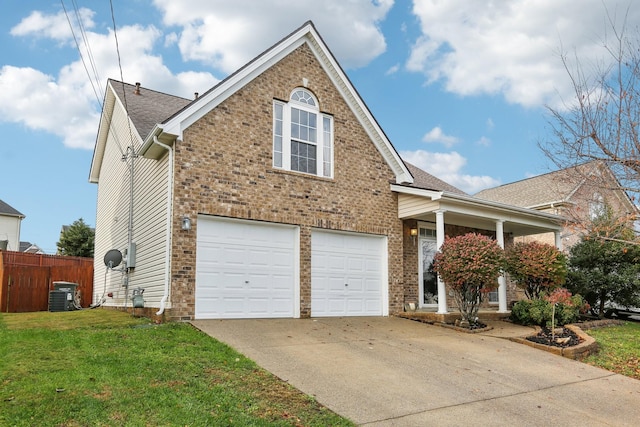 view of front of house with a front yard, central AC, and a garage