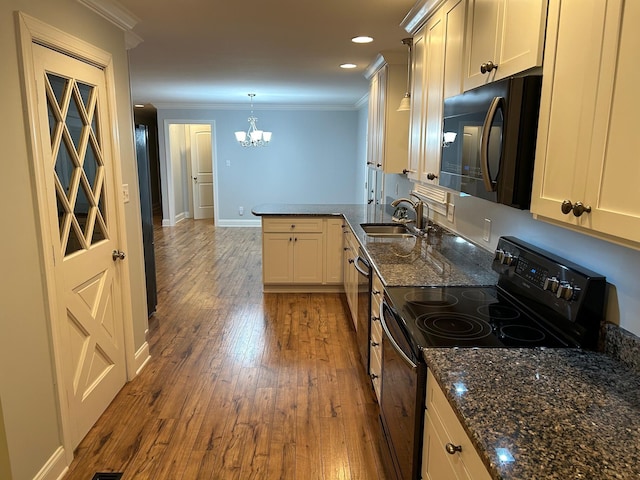 kitchen with black appliances, crown molding, sink, decorative light fixtures, and wood-type flooring