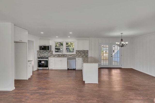 kitchen featuring white cabinets, dark hardwood / wood-style floors, appliances with stainless steel finishes, and french doors