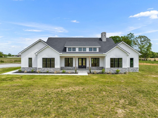 modern farmhouse style home with a front lawn and covered porch