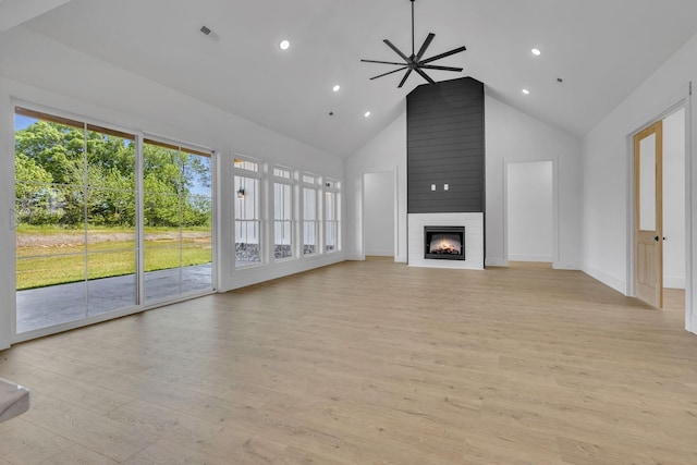 unfurnished living room featuring a fireplace, light hardwood / wood-style floors, high vaulted ceiling, and ceiling fan