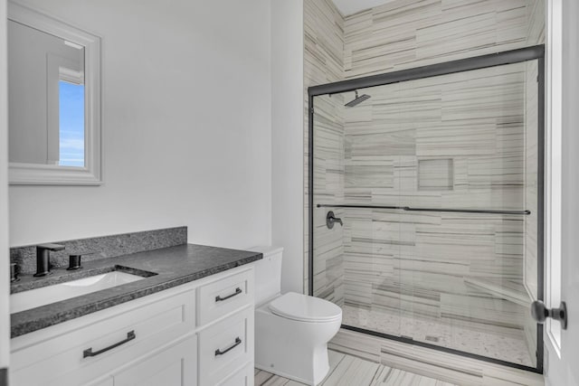 bathroom featuring vanity, toilet, and walk in shower