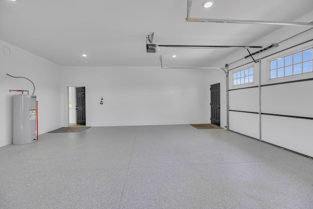 garage with electric water heater and a garage door opener