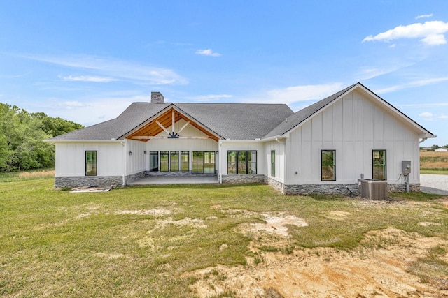 back of property with ceiling fan, a yard, a patio, and central air condition unit