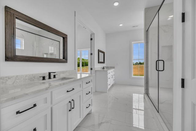 bathroom featuring vanity, an enclosed shower, and a wealth of natural light