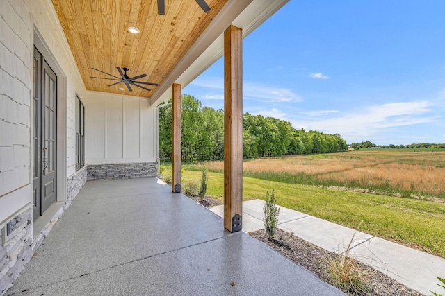 view of patio with a rural view and ceiling fan