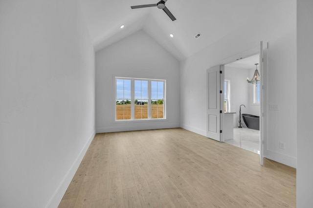 unfurnished living room with ceiling fan, high vaulted ceiling, and light hardwood / wood-style floors