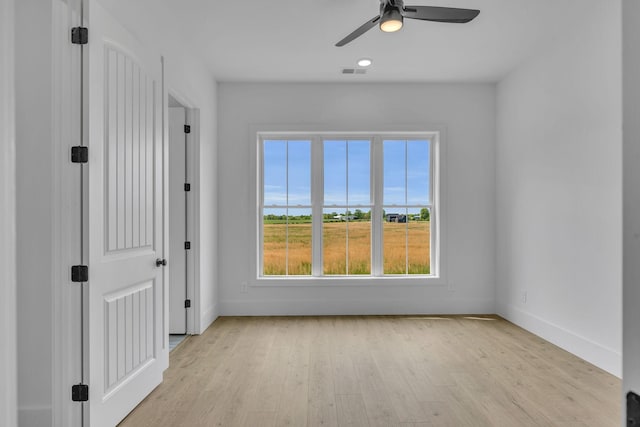 spare room featuring ceiling fan and light wood-type flooring