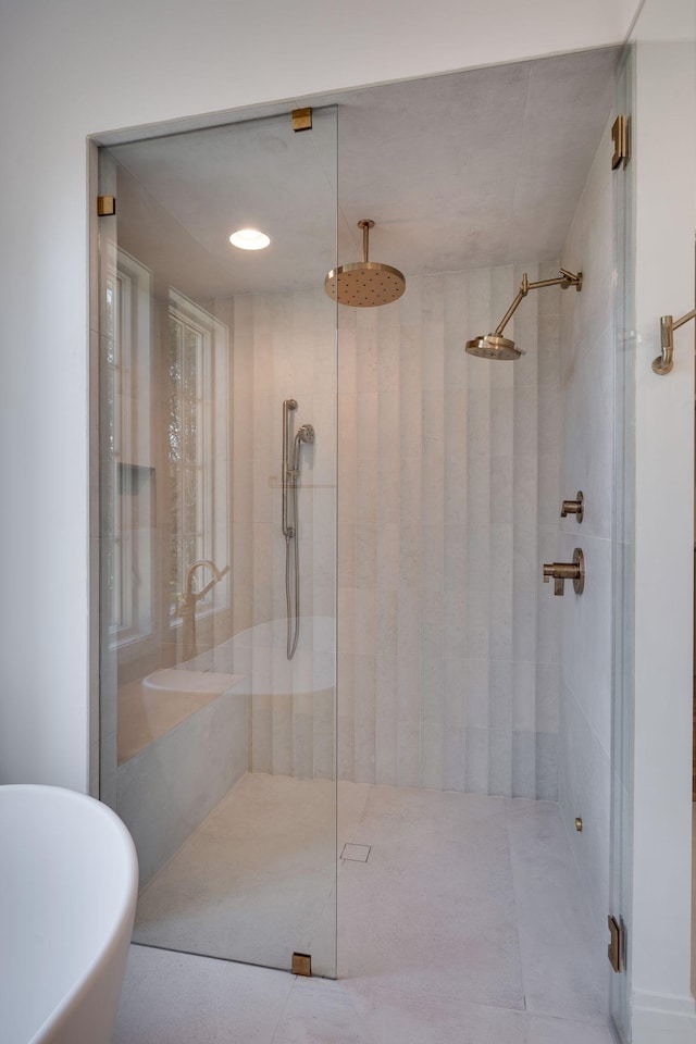 bathroom featuring separate shower and tub