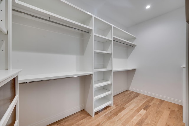 spacious closet featuring light hardwood / wood-style floors