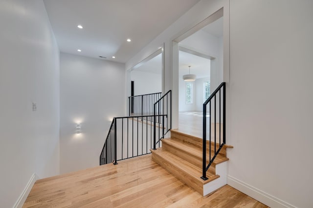 stairs featuring hardwood / wood-style flooring