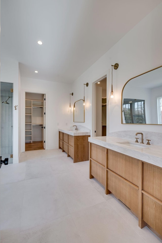 bathroom featuring vanity and an enclosed shower