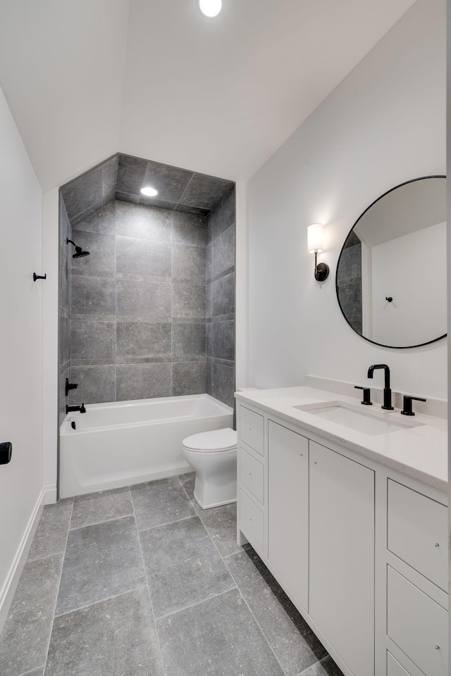 full bathroom with tiled shower / bath, vanity, and toilet