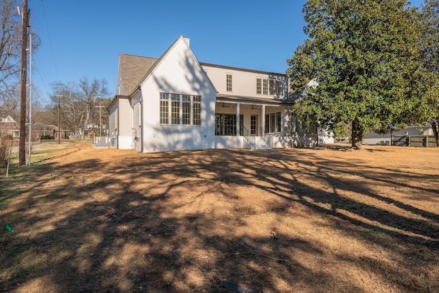 rear view of property featuring covered porch